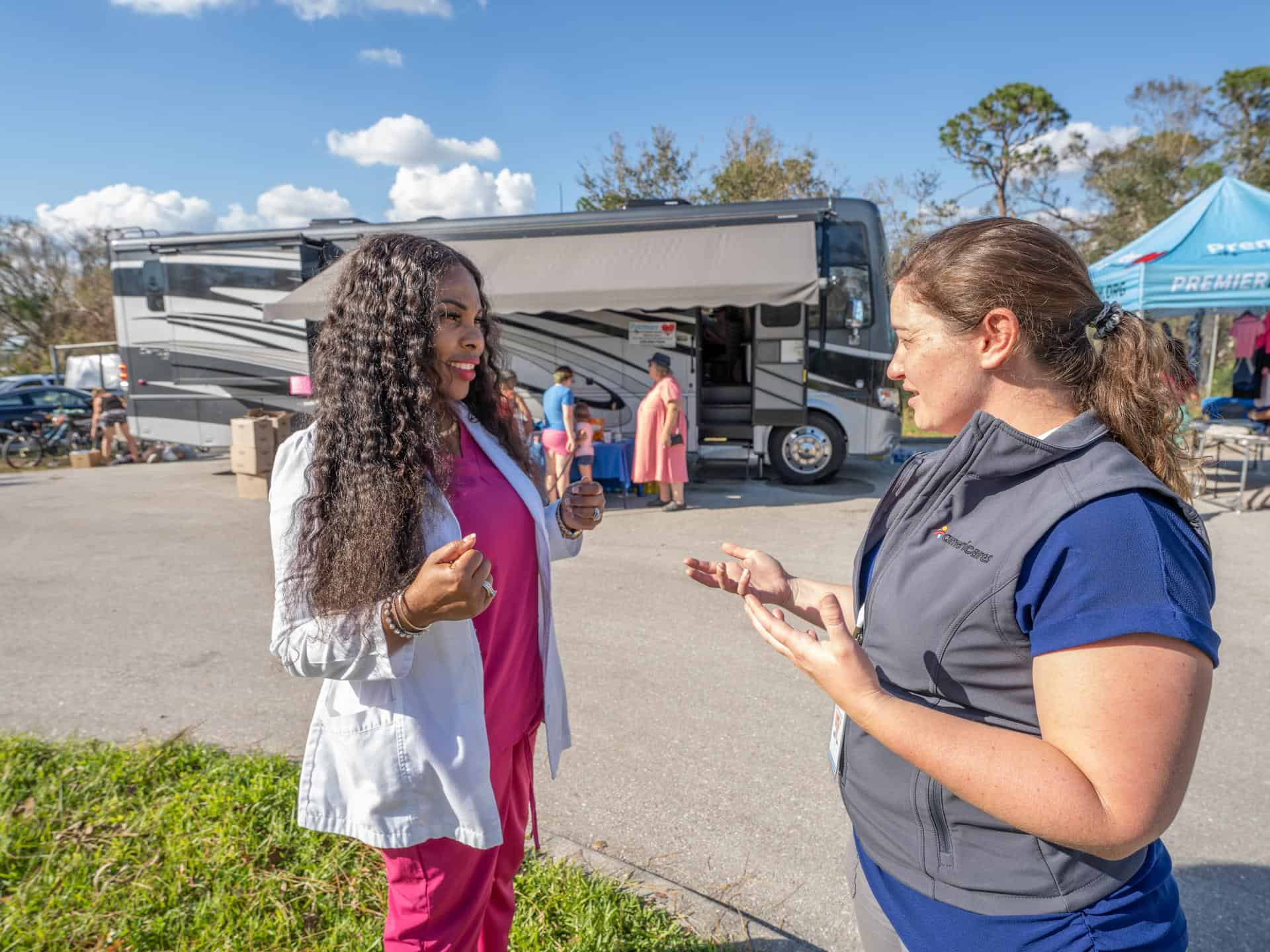 Deanie Singh, a registered, board-certified Nurse Practitioner and the Executive Director at Premier Mobile Health Services speaks with Mariel Fonteyn, Director, US Emergency Response Emergency Programs, in Ft. Meyers, Florida. October 4, 2022. (Photo: Mike Demas)